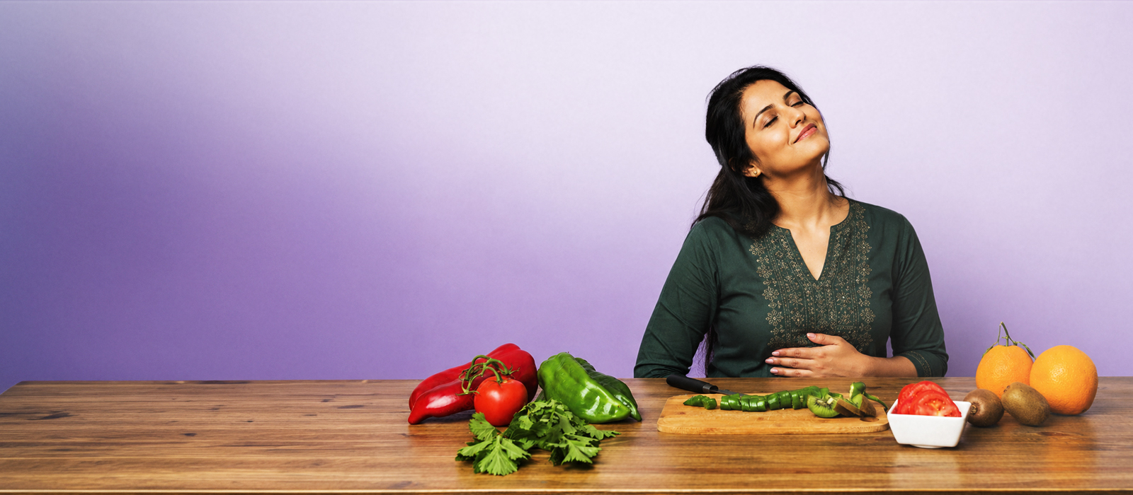Woman smiling with hands on stomach, feeling comfortable after a healthy meal