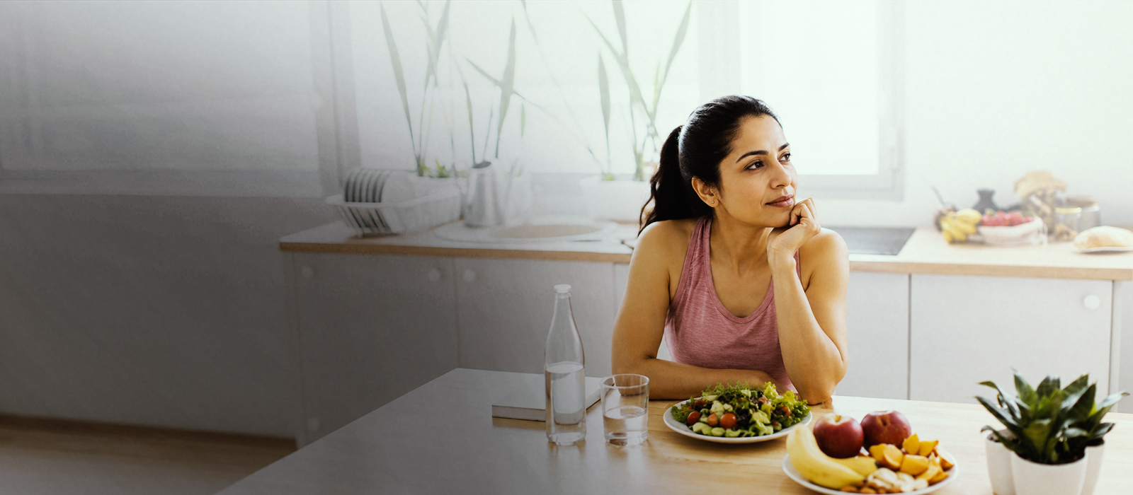 Woman smiling with hands on stomach, feeling comfortable after a healthy meal